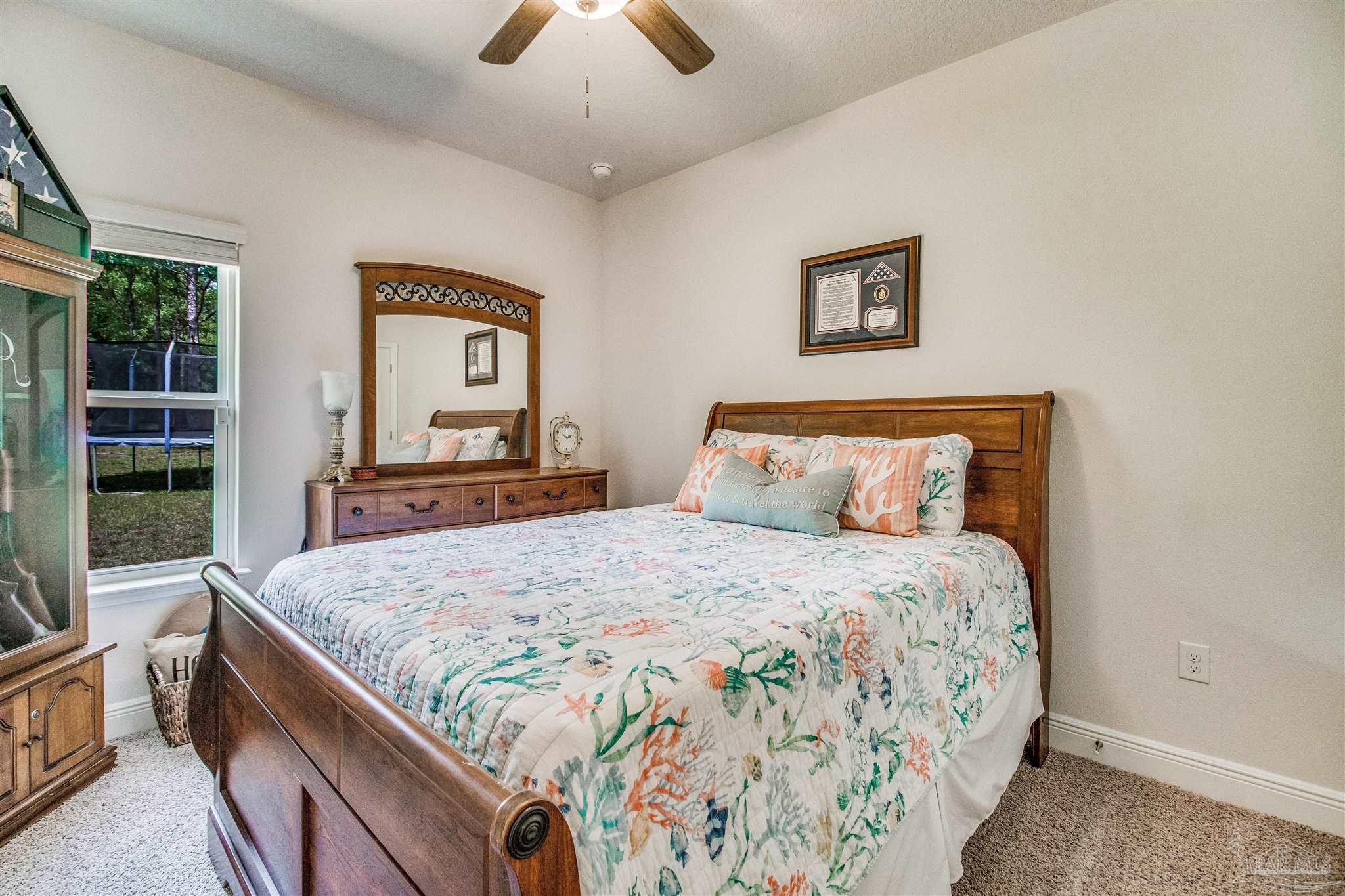 8024 Silver Maple Drive Milton, FL 32583 - Photo 26 of 43 a bedroom with bed and window