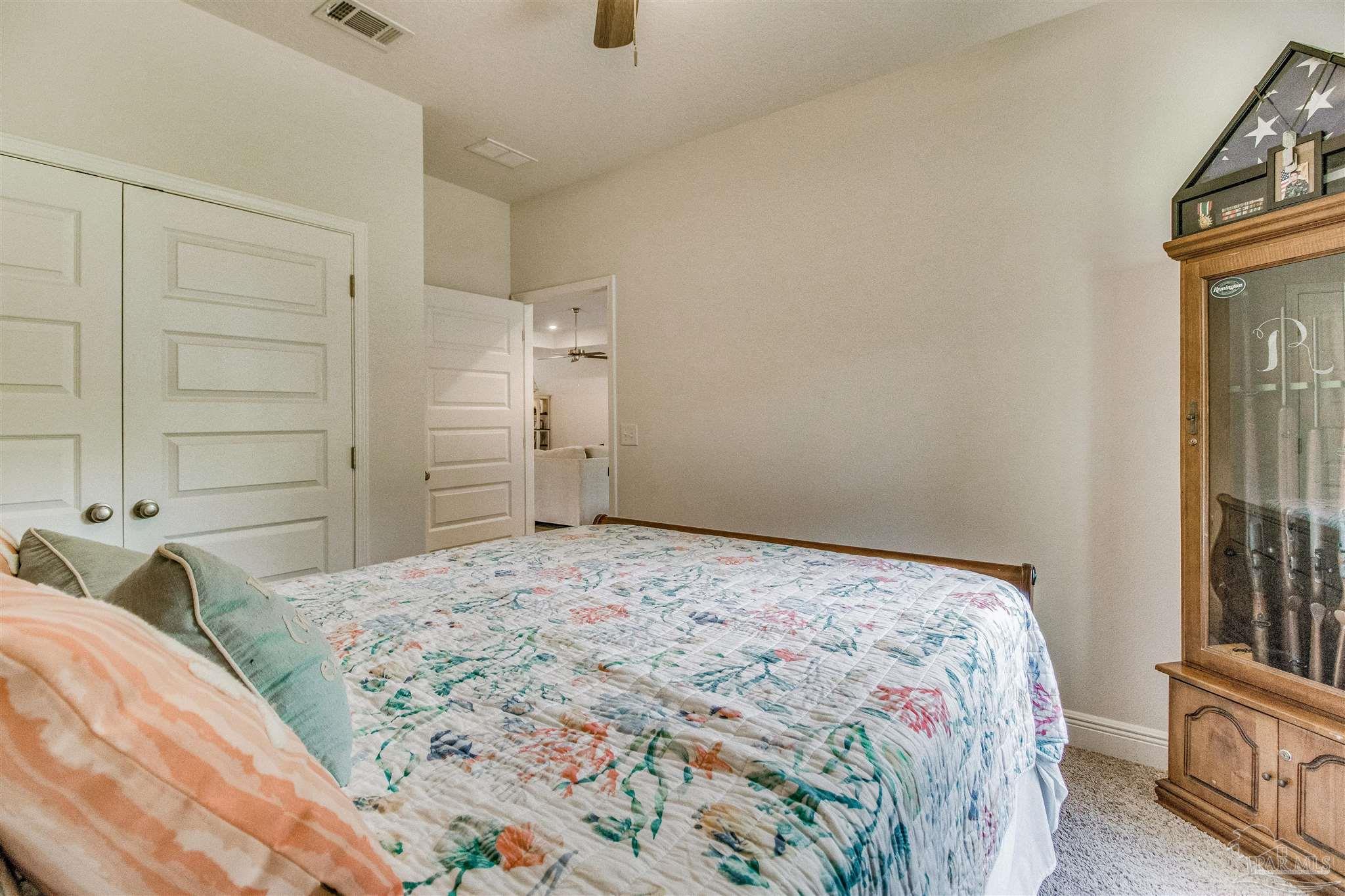 8024 Silver Maple Drive Milton, FL 32583 - Photo 29 of 43 a bedroom with a bed and a window