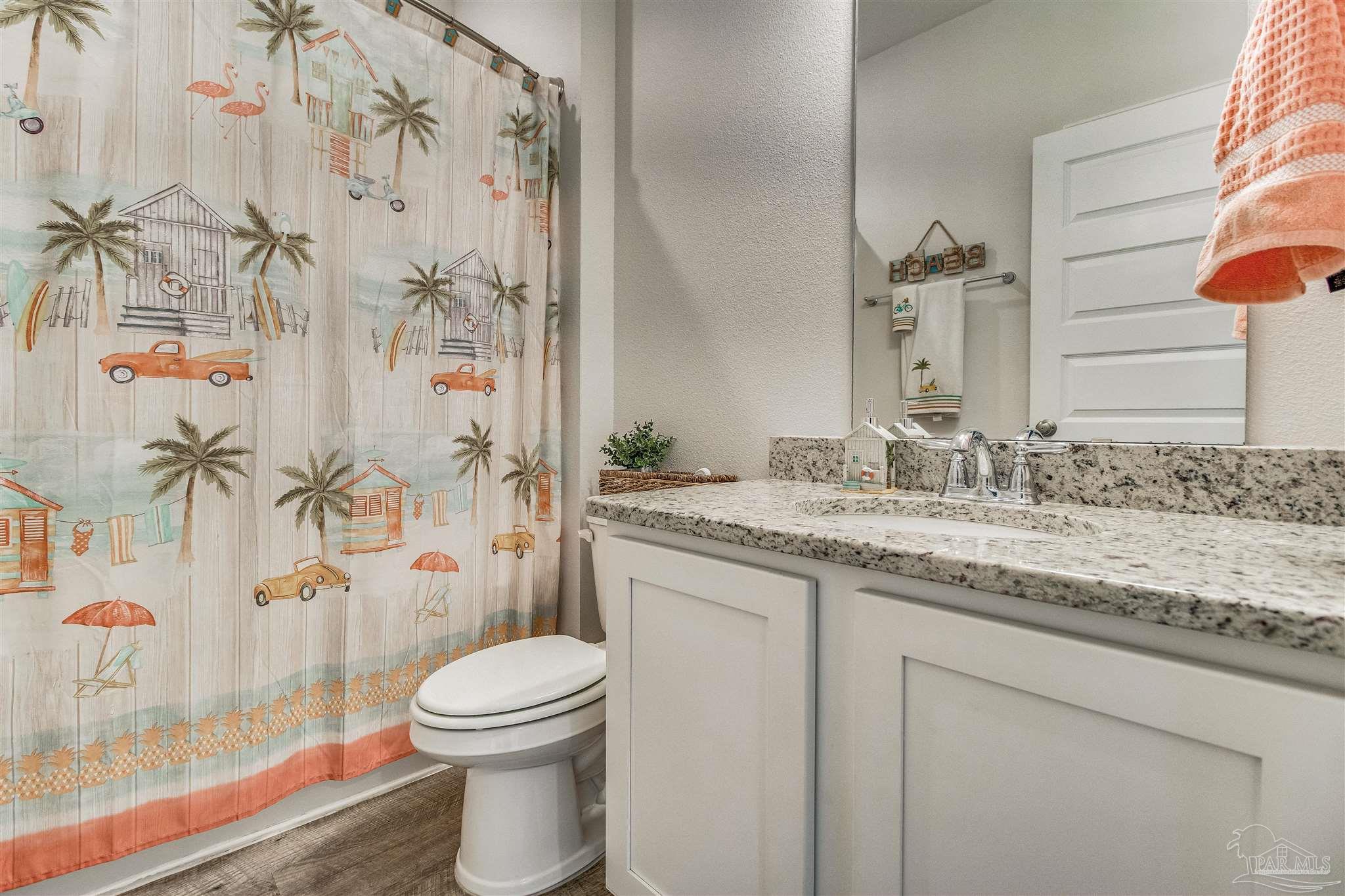 8024 Silver Maple Drive Milton, FL 32583 - Photo 30 of 43 a bathroom with a granite countertop sink toilet and shower