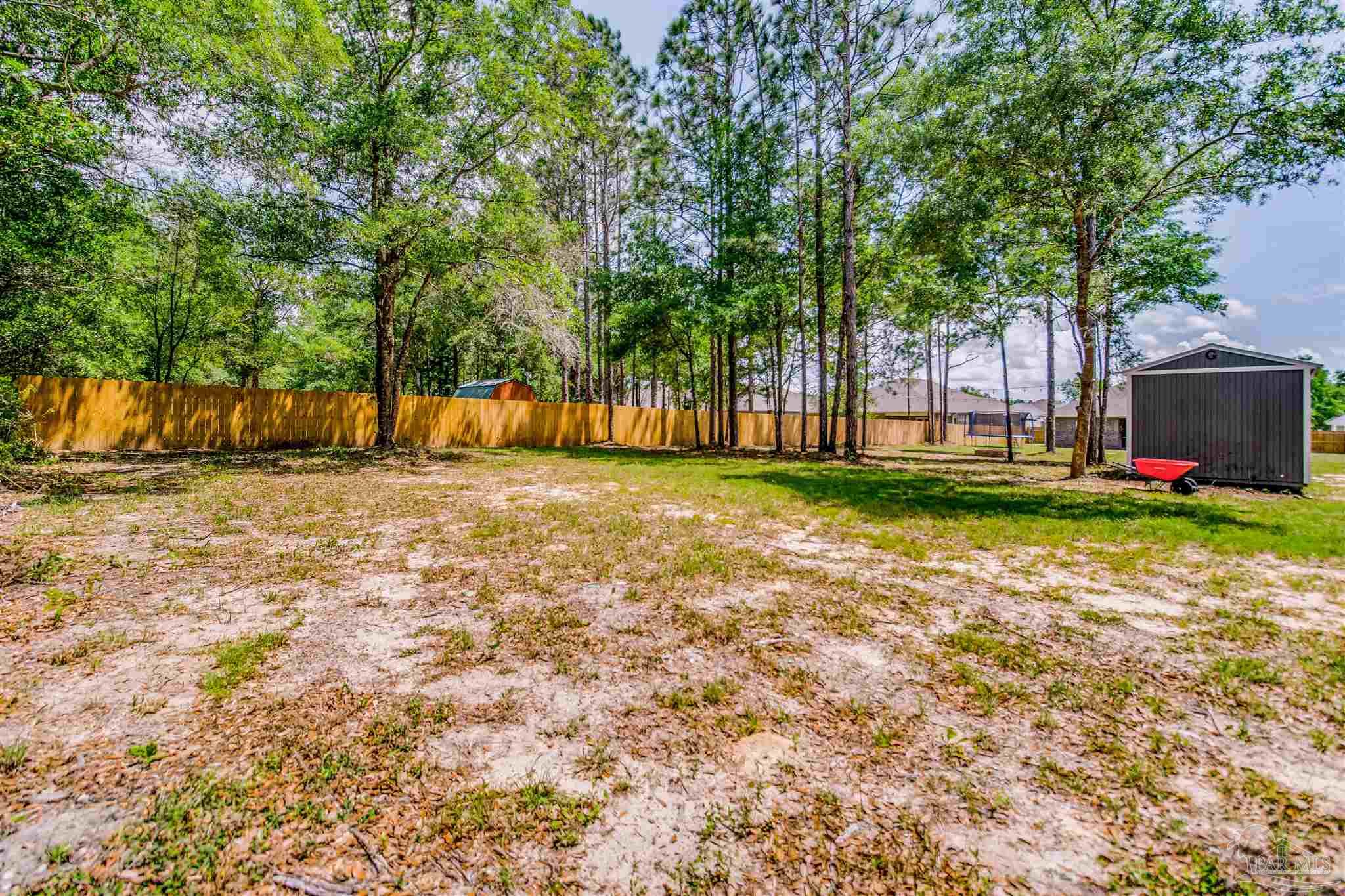 8024 Silver Maple Drive Milton, FL 32583 - Photo 32 of 43 a view of a backyard with large trees