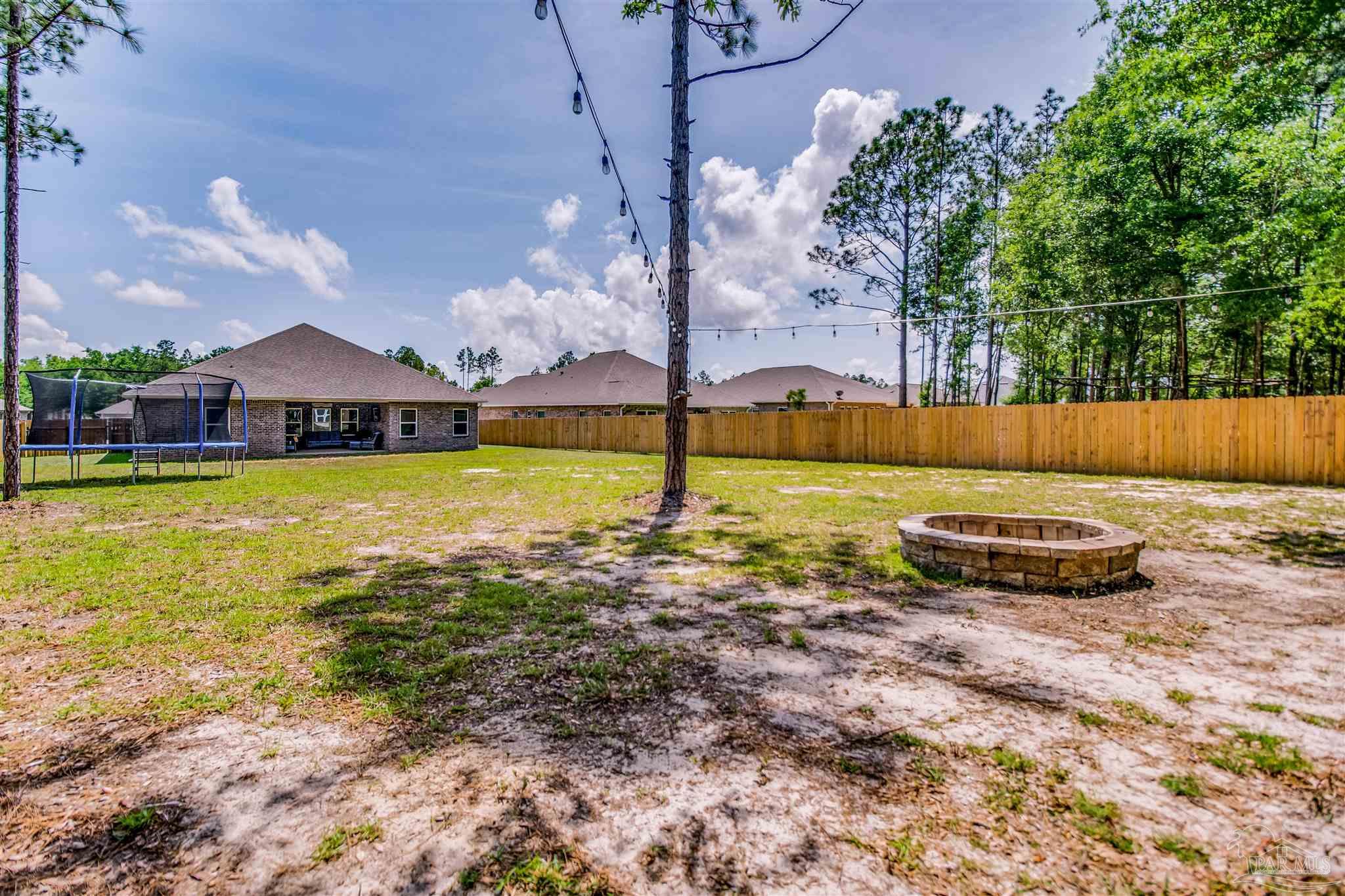 8024 Silver Maple Drive Milton, FL 32583 - Photo 37 of 43 a view of a swimming pool with a yard