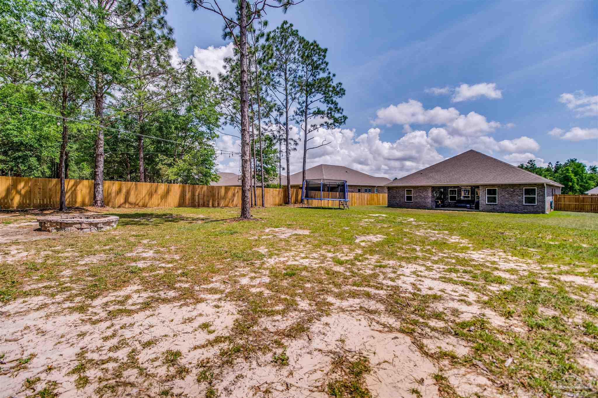 8024 Silver Maple Drive Milton, FL 32583 - Photo 38 of 43 a view of a house with a yard