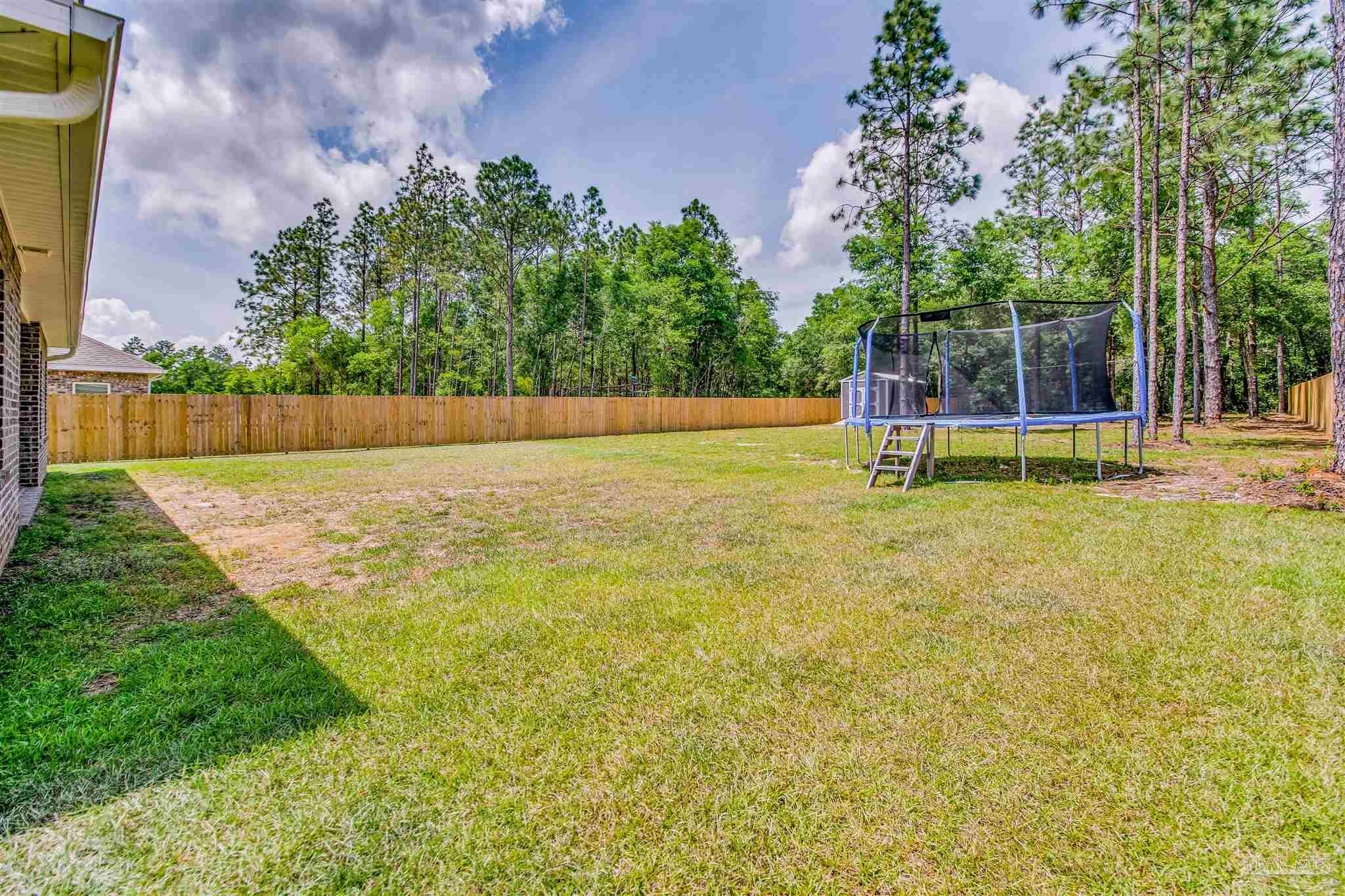 8024 Silver Maple Drive Milton, FL 32583 - Photo 39 of 43 a view of a swimming pool with a yard