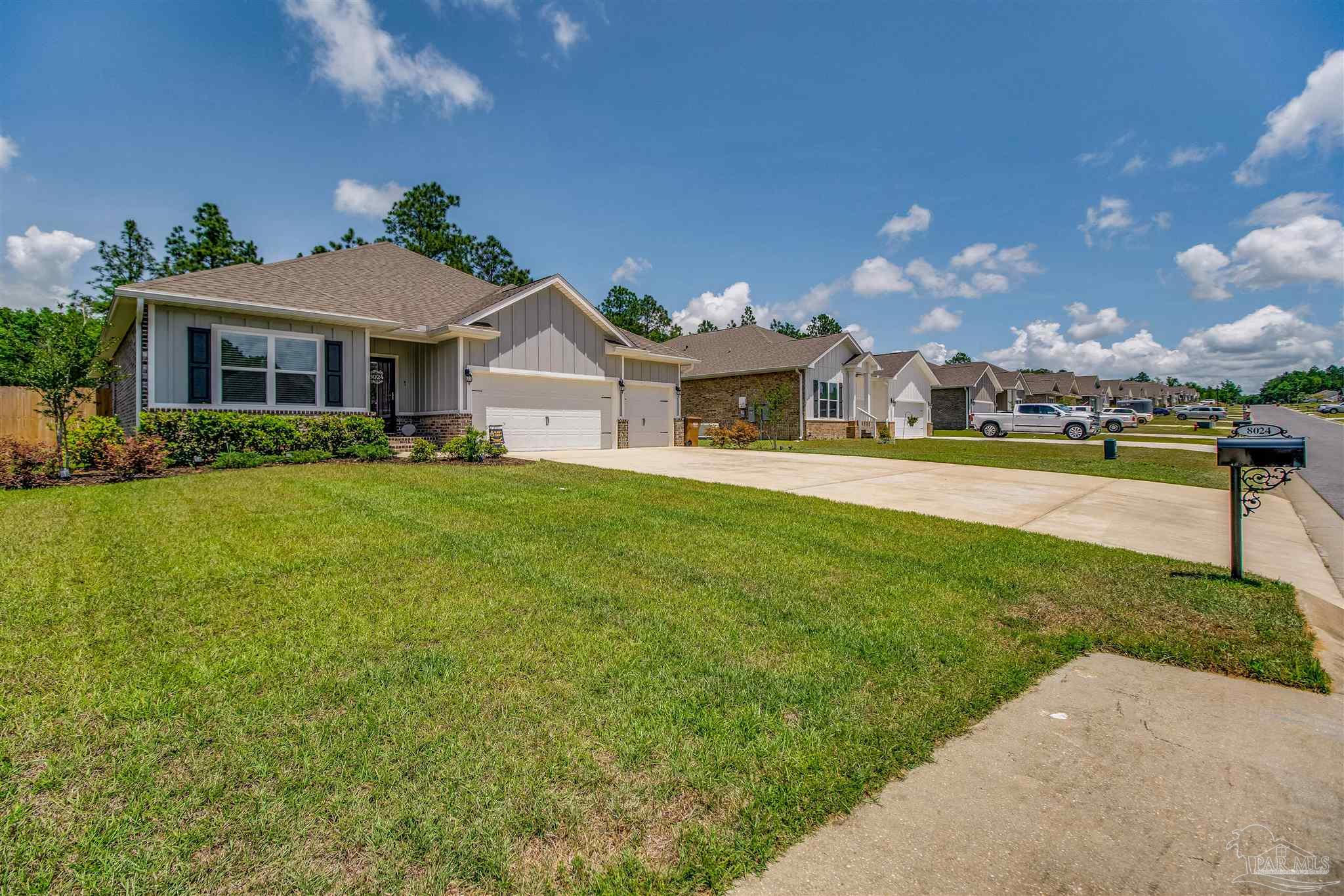 8024 Silver Maple Drive Milton, FL 32583 - Photo 42 of 43 a front view of a house with a yard