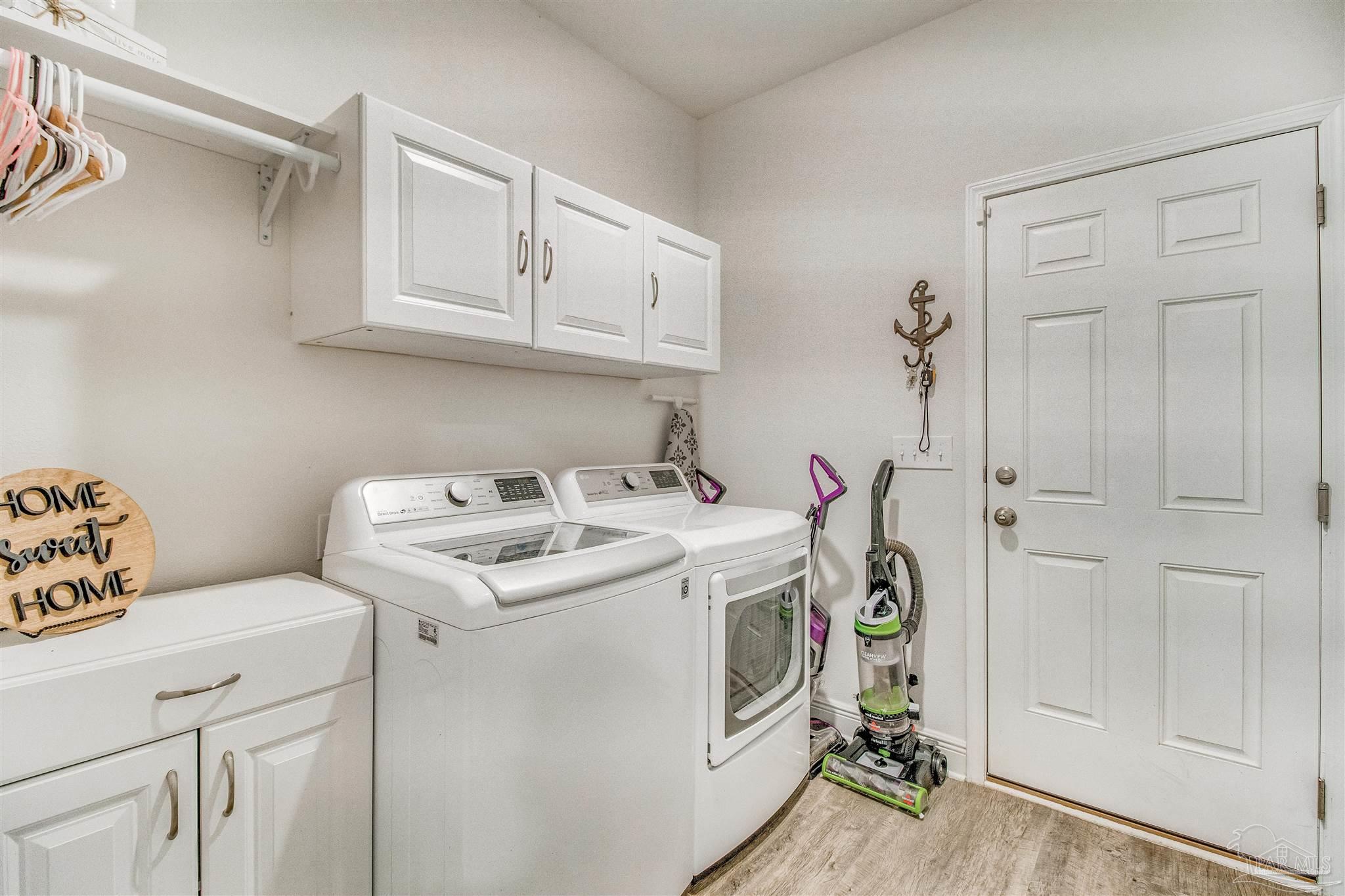 8024 Silver Maple Drive Milton, FL 32583 - Photo 43 of 43 a utility room with dryer and washer