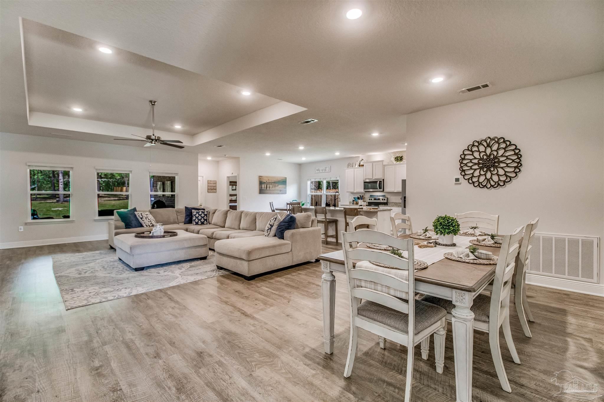 8024 Silver Maple Drive Milton, FL 32583 - Photo 8 of 43 a living room with furniture and a wooden floor