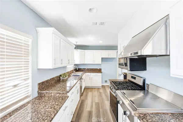 a kitchen with a stove a sink and a refrigerator