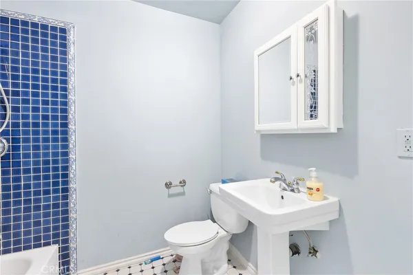 a bathroom with a sink a toilet and mirror
