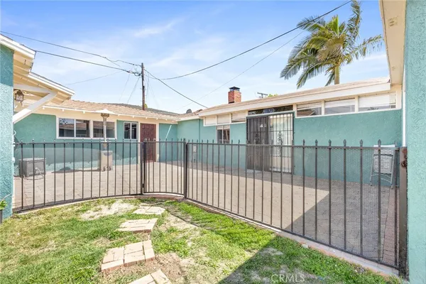 a view of a wrought iron fences in front of house