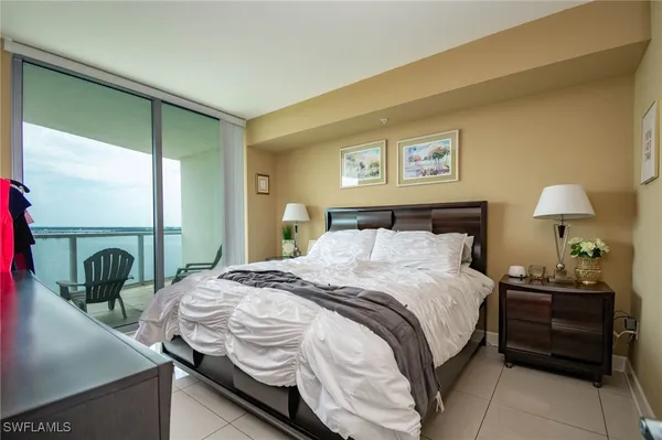 a bedroom with a bed and a painting on the wall