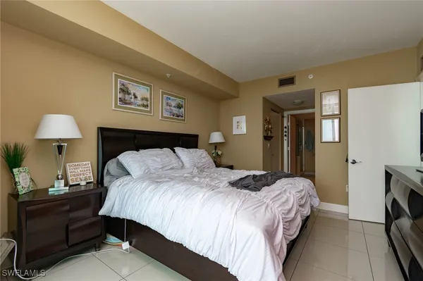 a bedroom with a bed and a lamp on table