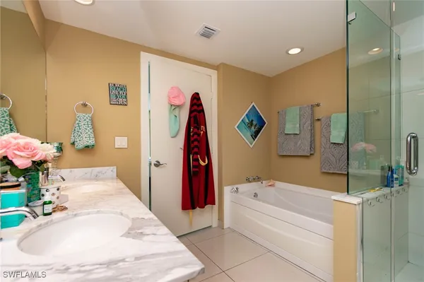 a bathroom with a tub sink and a mirror
