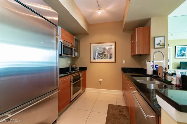 a kitchen with granite countertop stainless steel appliances and wooden cabinets