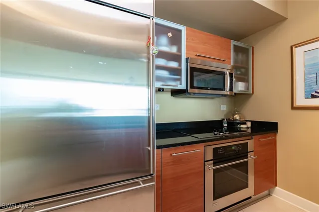 a kitchen with granite countertop stainless steel appliances and cabinets