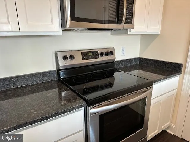 a stove top oven sitting inside of a kitchen