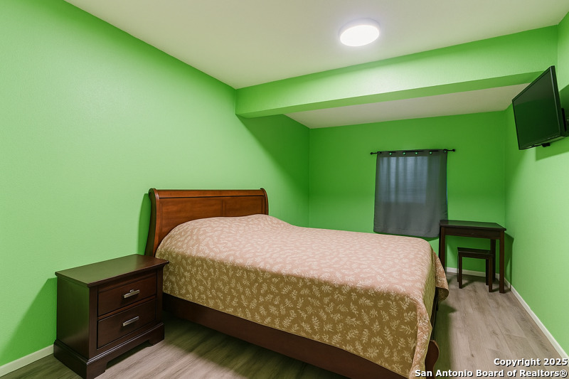 2518 Ridge Leaf San Antonio, TX 78251 - Photo 11 of 19 a bedroom with a bed and a flat screen tv