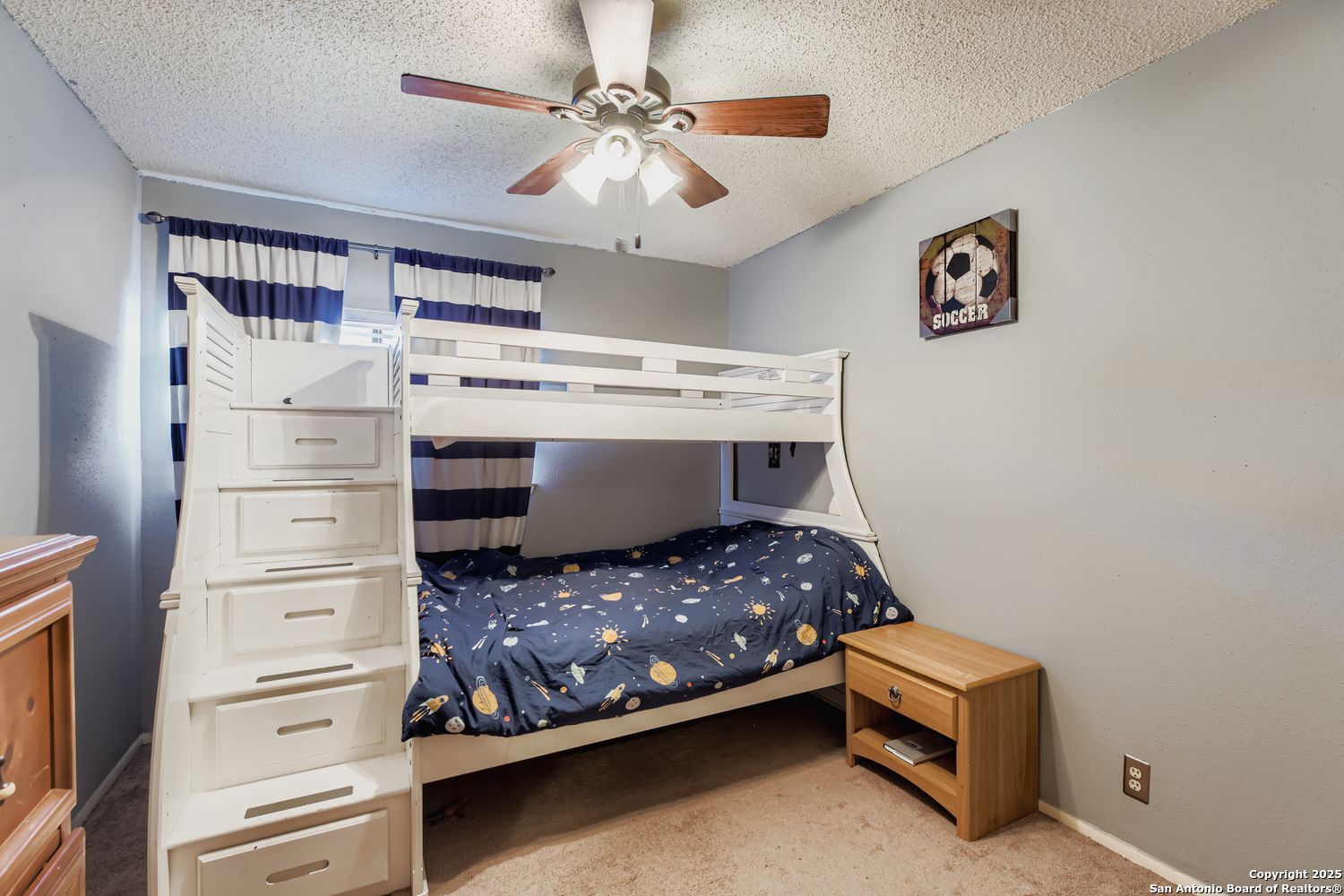 2518 Ridge Leaf San Antonio, TX 78251 - Photo 15 of 19 a bedroom with a bed and a chandelier
