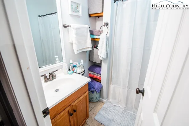 a bathroom with a sink and a shower curtain