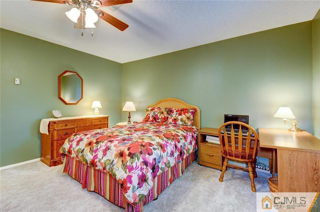 781 A Risley Road Monroe Township, NJ 08831 - Photo 12 of 21 a bedroom with two beds and a chandelier