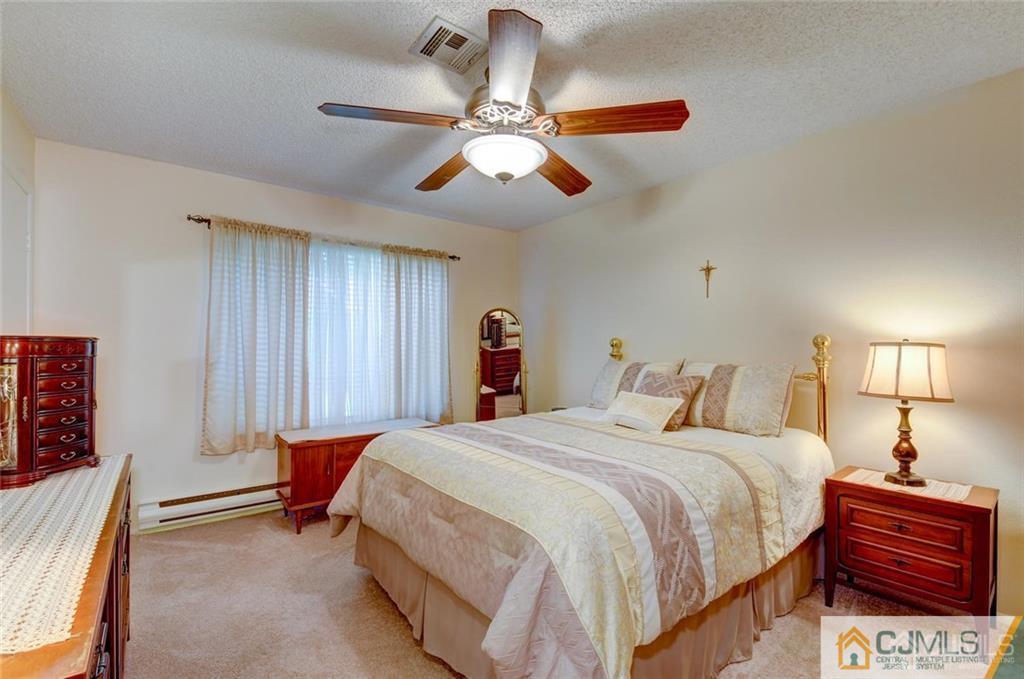 781 A Risley Road Monroe Township, NJ 08831 - Photo 15 of 21 a bedroom with a bed and a chandelier