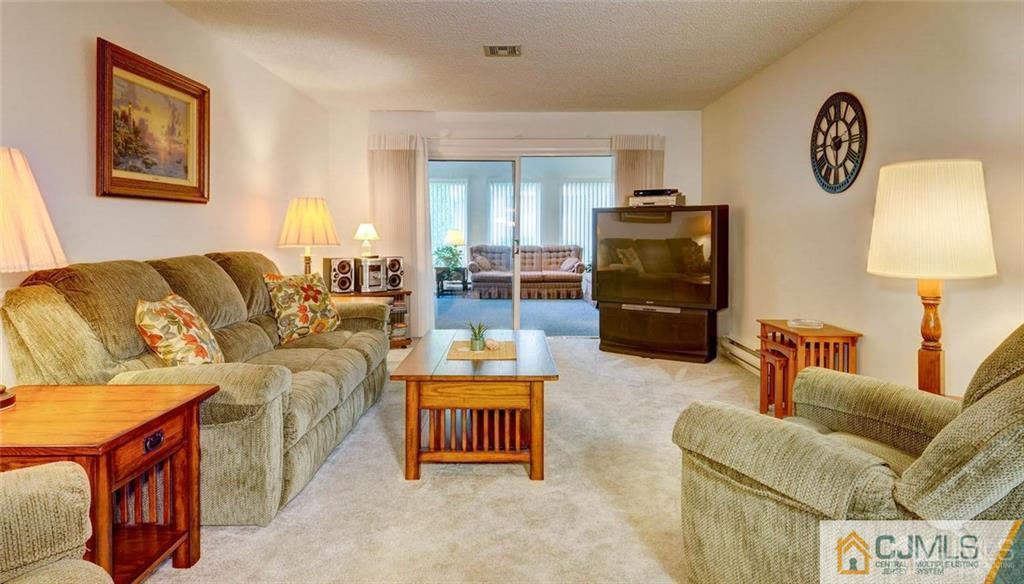781 A Risley Road Monroe Township, NJ 08831 - Photo 3 of 21 a living room with furniture and a flat screen tv