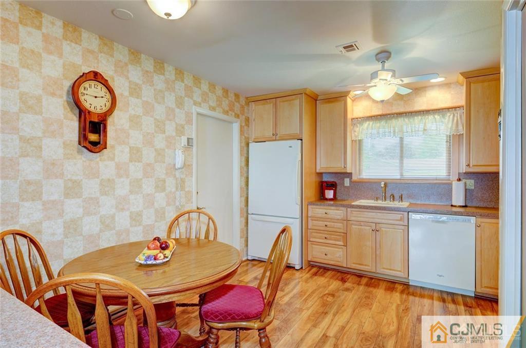 781 A Risley Road Monroe Township, NJ 08831 - Photo 7 of 21 a kitchen with stainless steel appliances kitchen island granite countertop a dining table chairs and a refrigerator
