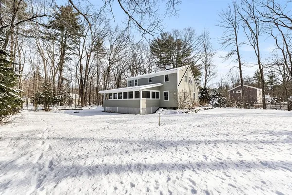 a view of a house with a snow in the yard