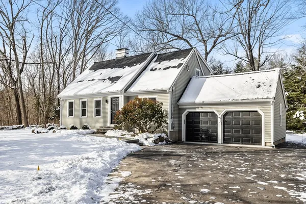 a view of a house with a yard covered in snow