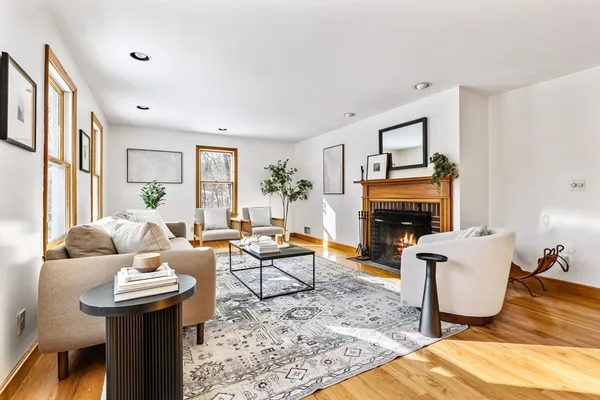 a living room with furniture a window and a fireplace