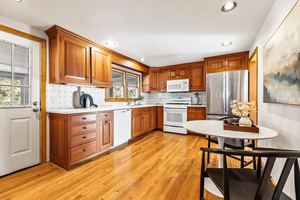 a kitchen with a table chairs stove and cabinets