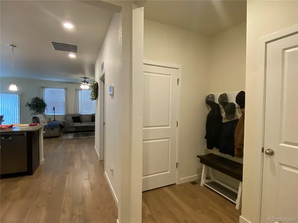 a view of a living room with furniture and wooden floor