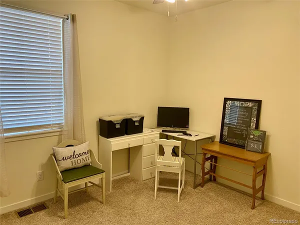 a view of a workspace with furniture