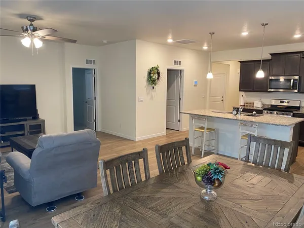 a living room with furniture and kitchen view