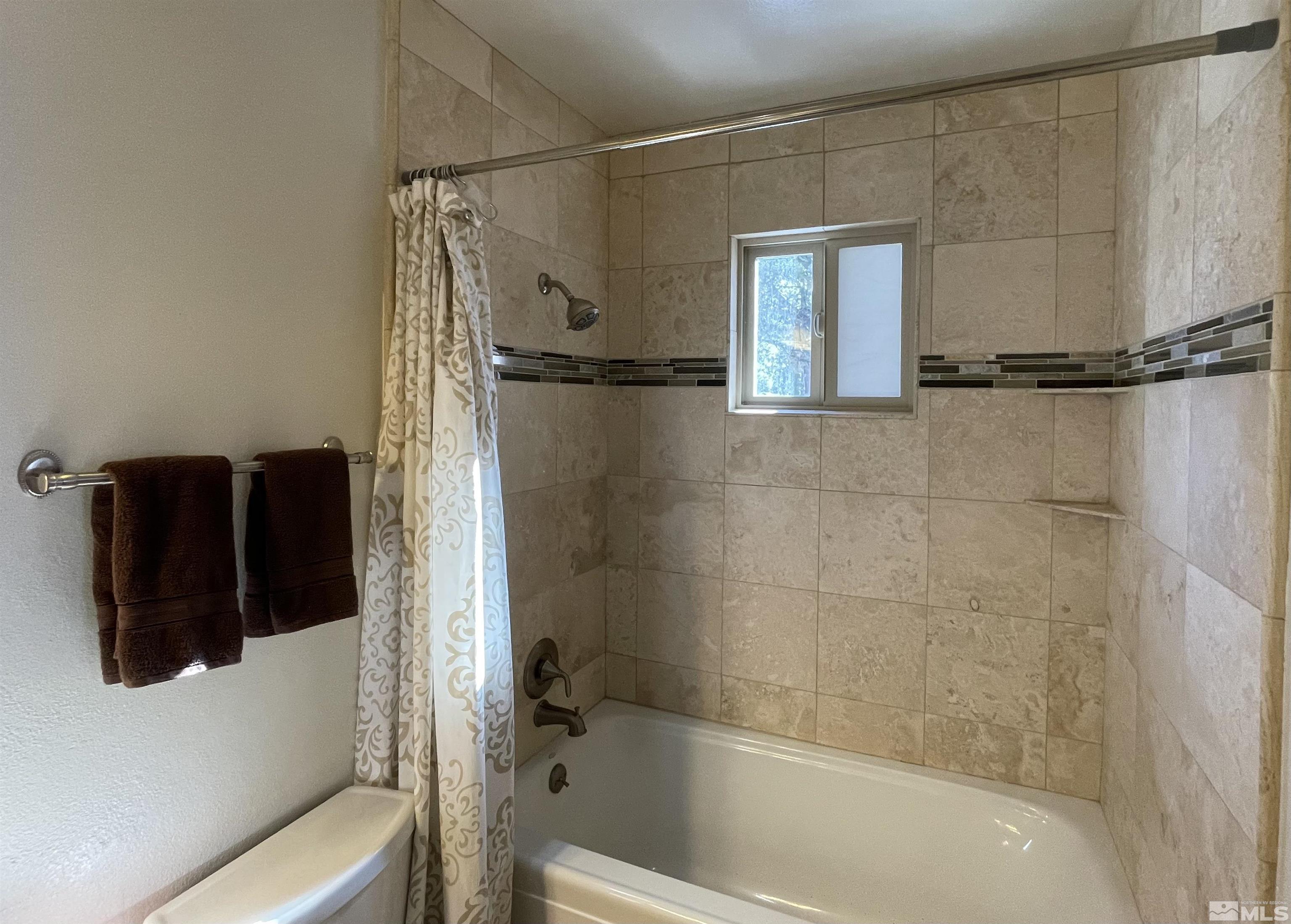 126 Spooner Lane, Unit B Stateline, NV 89449 - Photo 14 of 37 a bathroom with a bathtub and a shower