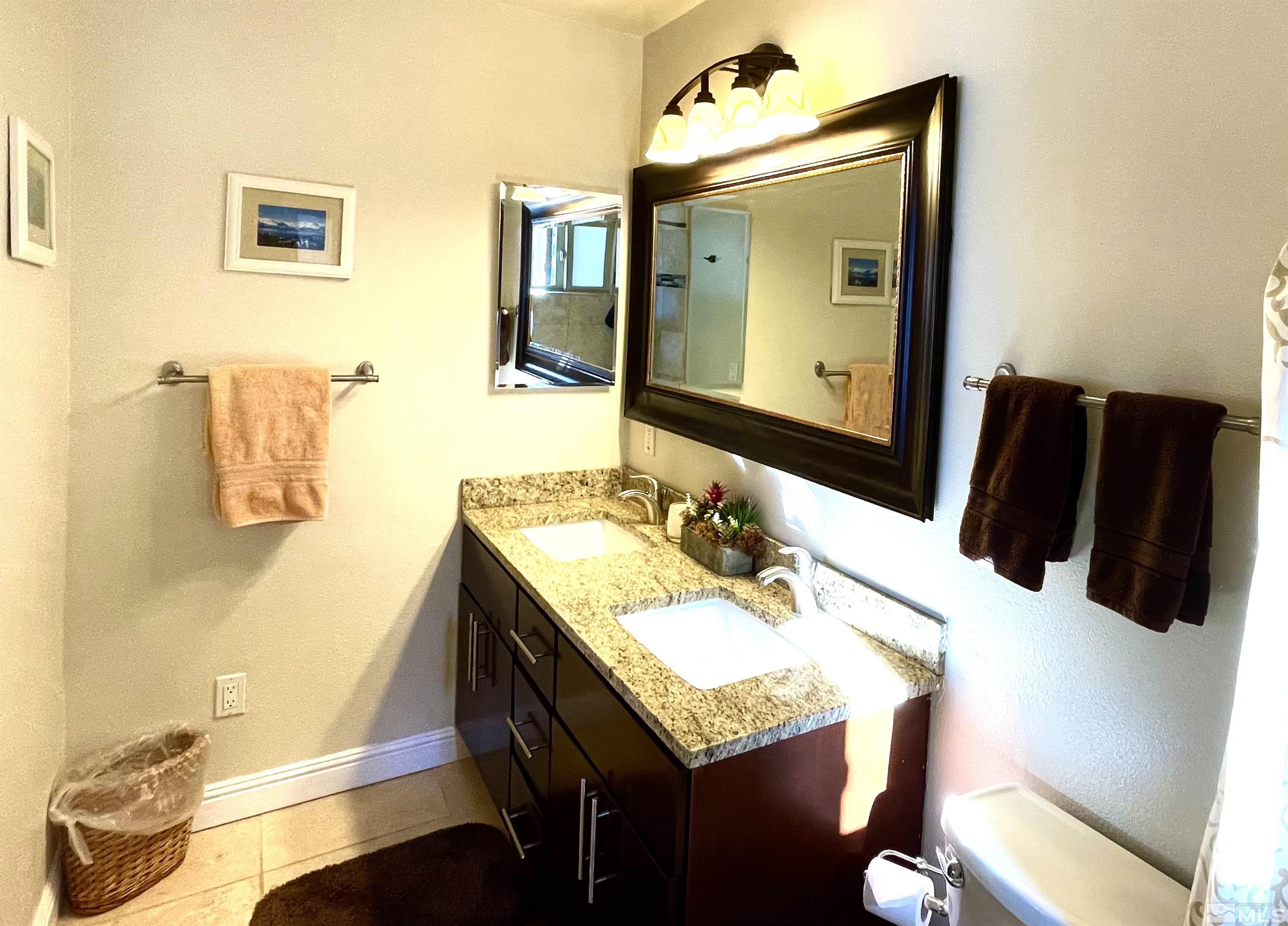 126 Spooner Lane, Unit B Stateline, NV 89449 - Photo 19 of 37 a bathroom with a sink vanity and a mirror