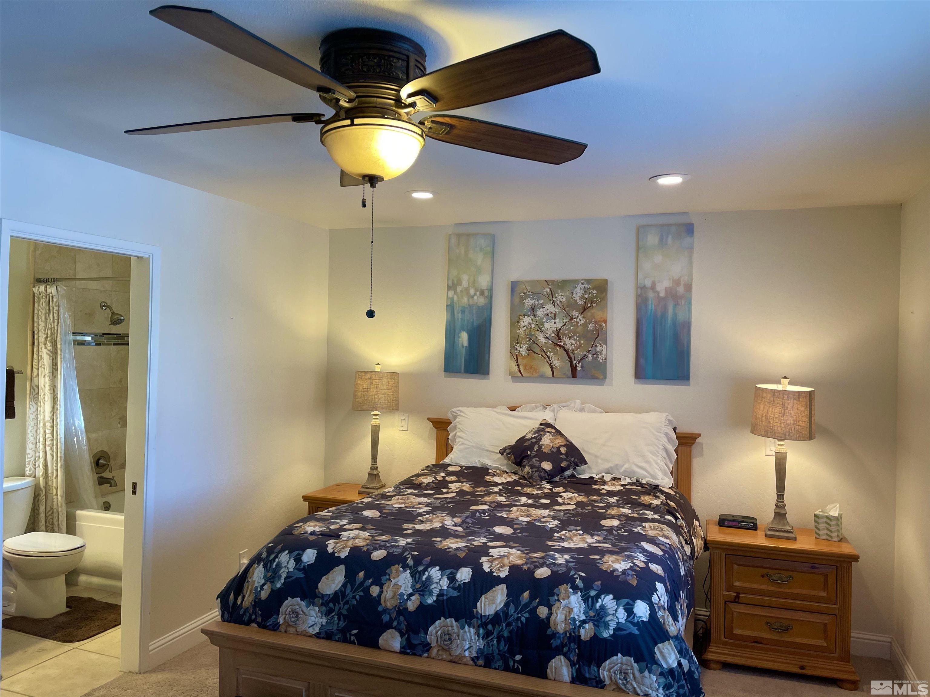 126 Spooner Lane, Unit B Stateline, NV 89449 - Photo 22 of 37 a bedroom with a bed and a lamp