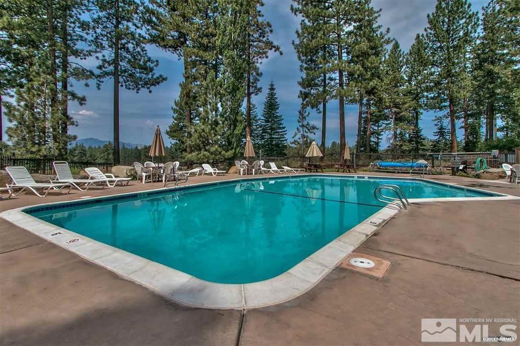 126 Spooner Lane, Unit B Stateline, NV 89449 - Photo 28 of 37 a view of a swimming pool with a fountain and trees