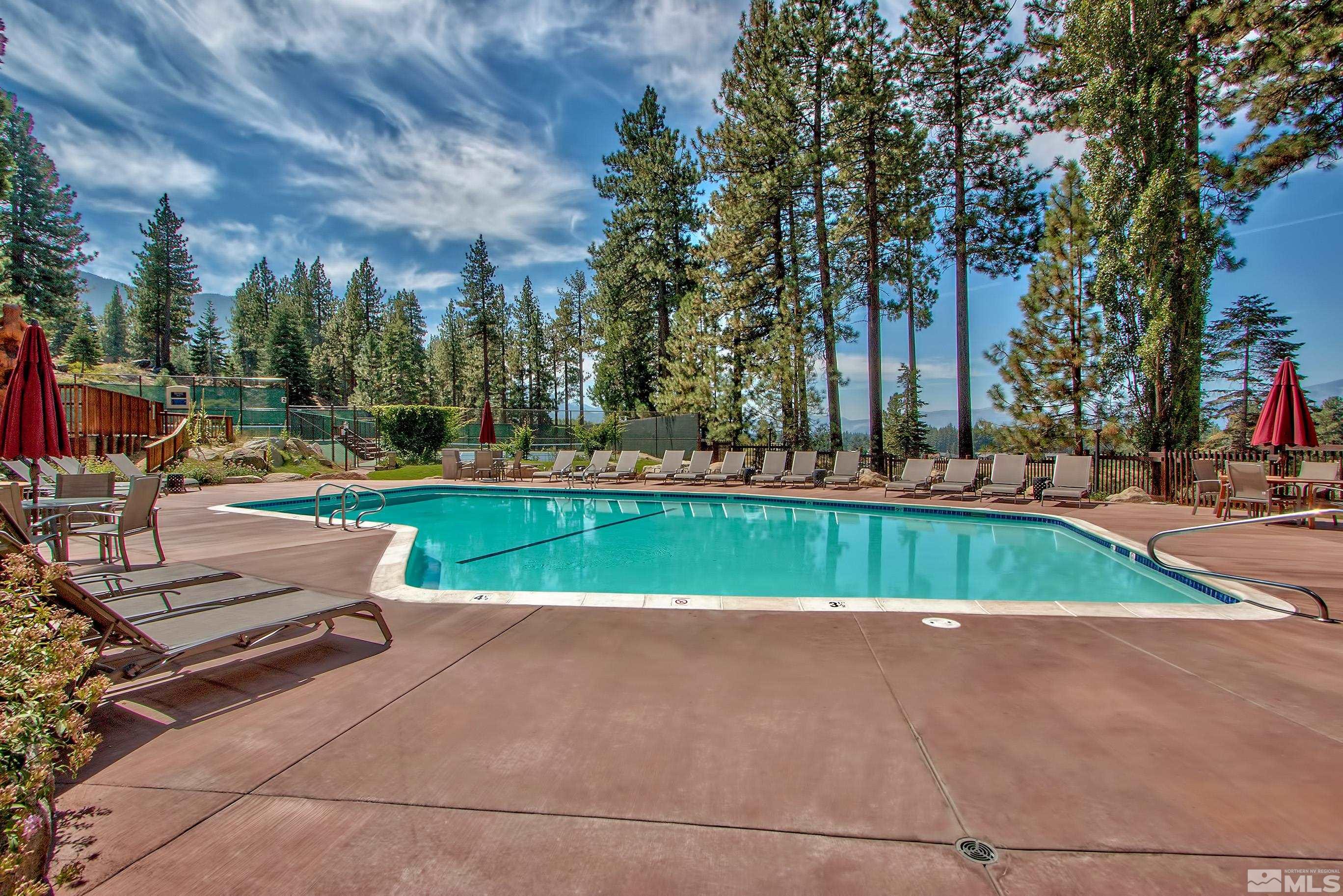 126 Spooner Lane, Unit B Stateline, NV 89449 - Photo 29 of 37 a view of swimming pool with outdoor seating and trees in the background