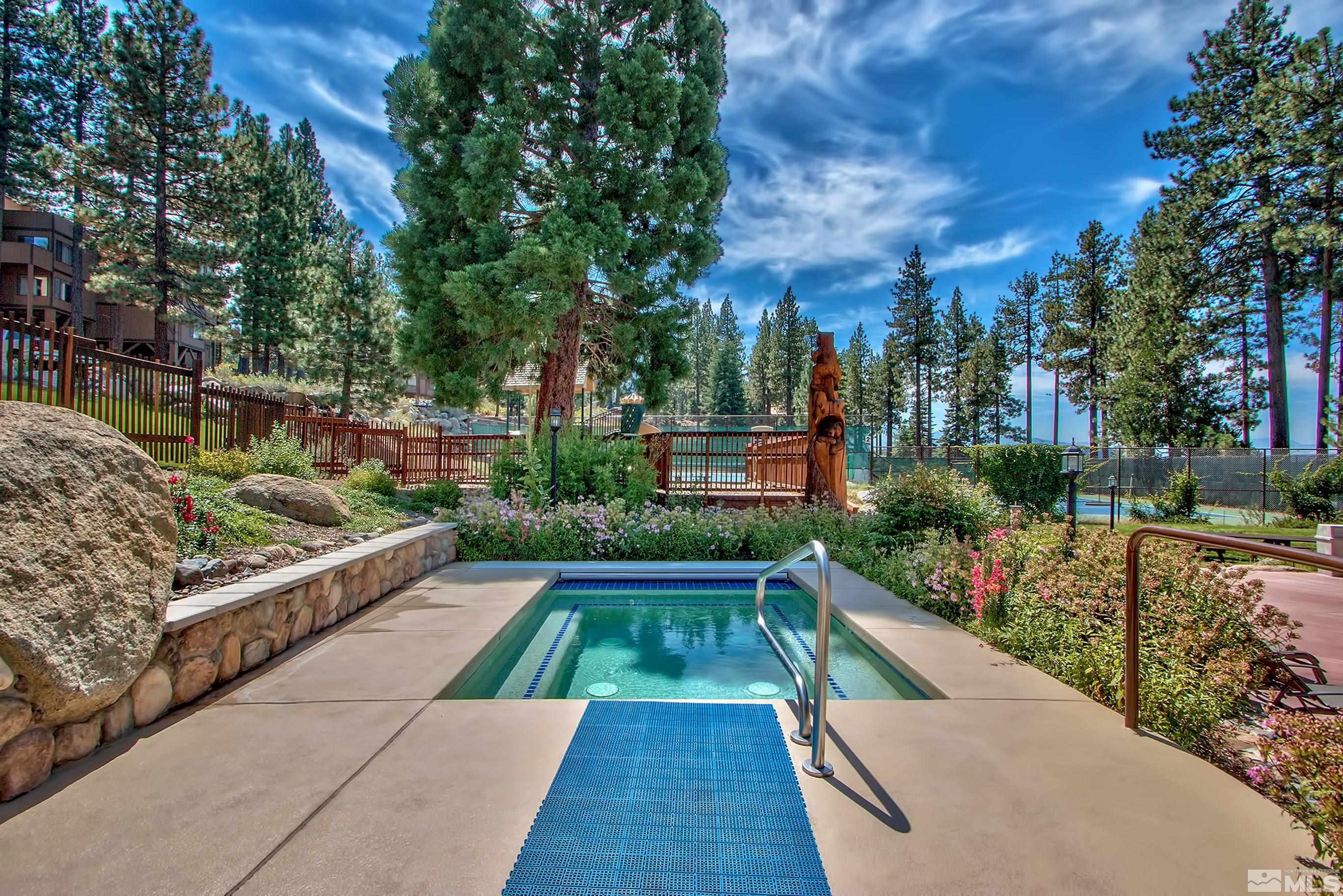 126 Spooner Lane, Unit B Stateline, NV 89449 - Photo 30 of 37 a view of a swimming pool with a garden