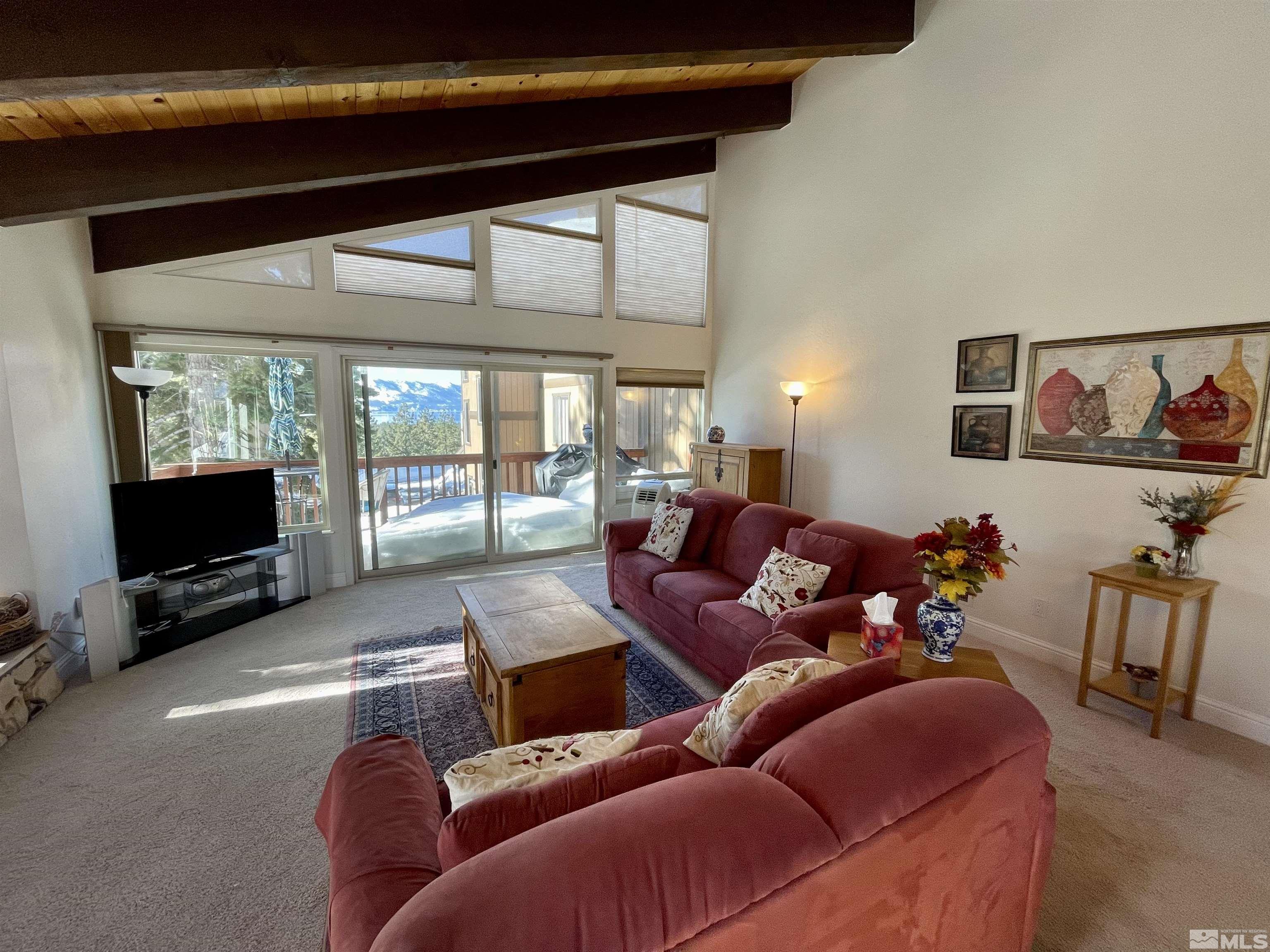 126 Spooner Lane, Unit B Stateline, NV 89449 - Photo 9 of 37 a living room with furniture a flat screen tv and a fireplace