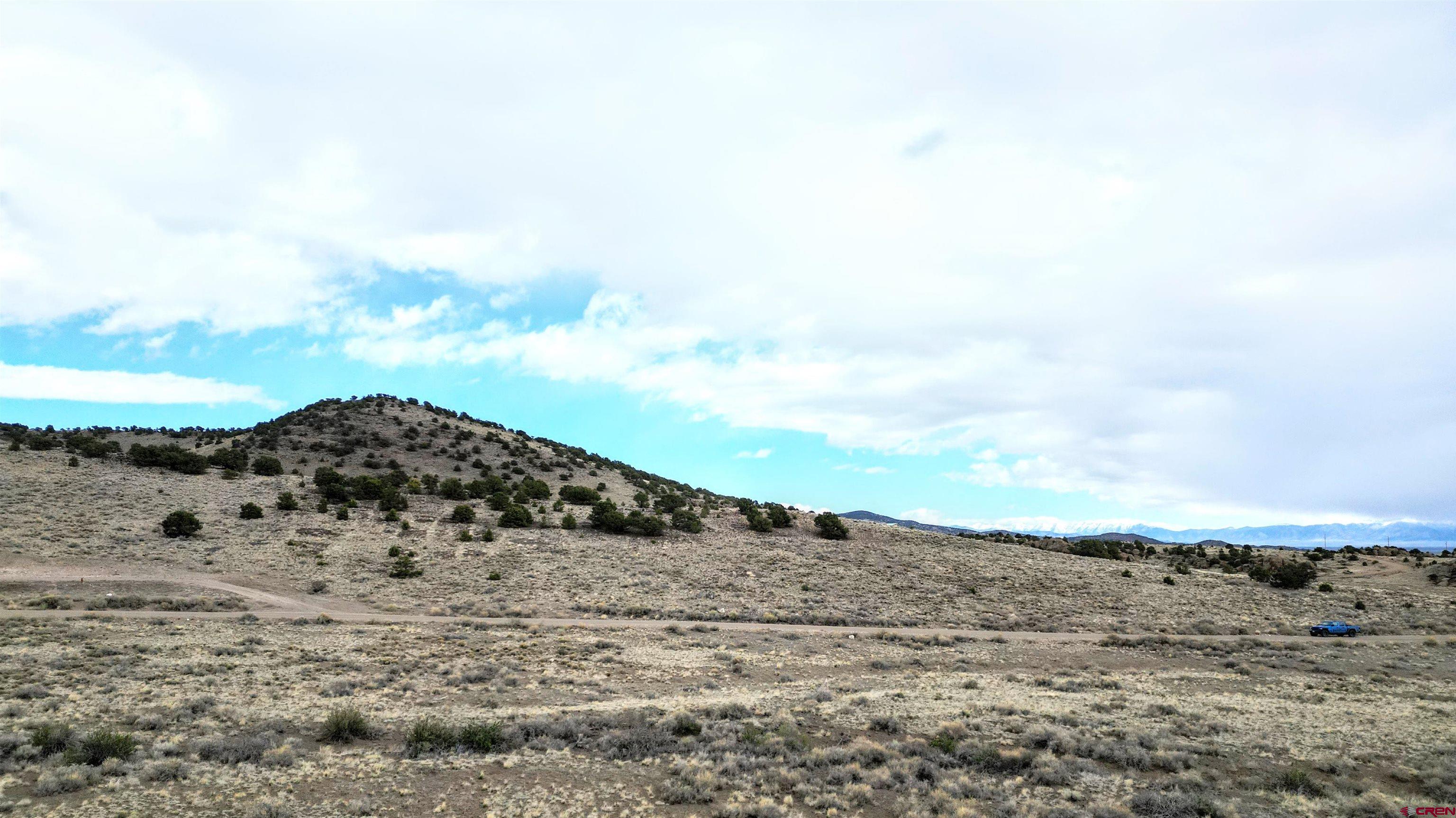 17 Ghost Mine Ranch Del Norte, CO 81132 - Photo 22 of 33 a view of a dry field with mountains in the background