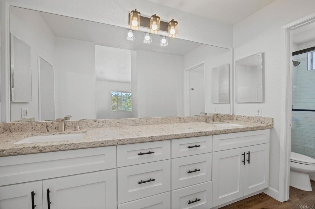 4595 Blackwell Road Oceanside, CA 92056 - Photo 29 of 47 a bathroom with a granite countertop sink and mirror