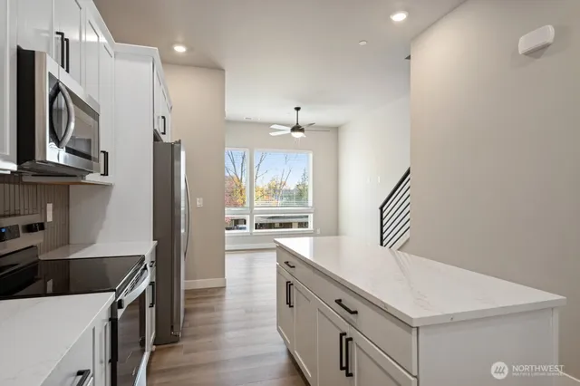 a kitchen with a sink a stove and cabinets