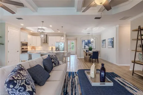 a living room with furniture and kitchen view