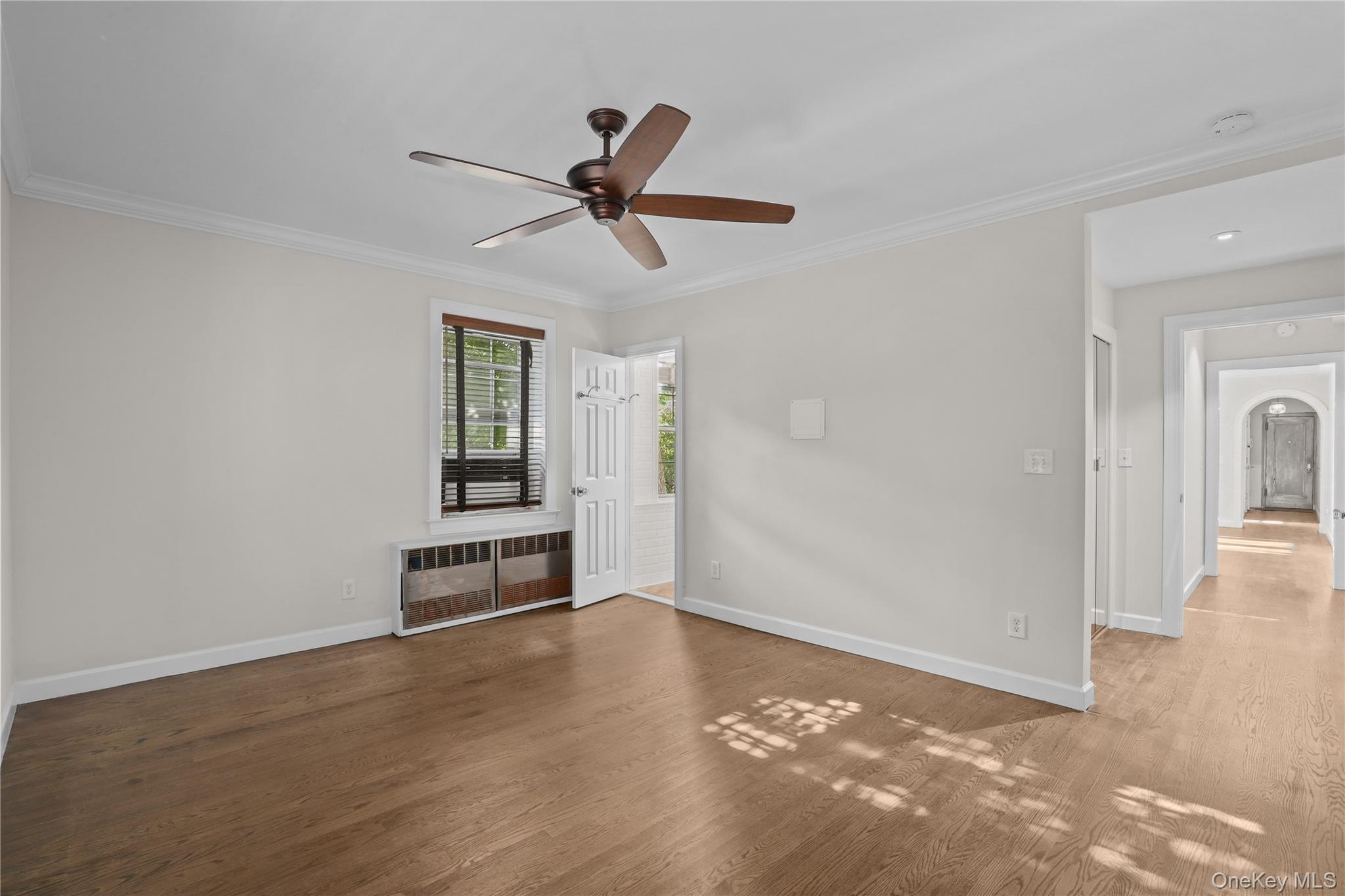6 Brooklands, Unit GC Bronxville, NY 10708 - Photo 11 of 17 a view of a livingroom with wooden floor and a ceiling fan