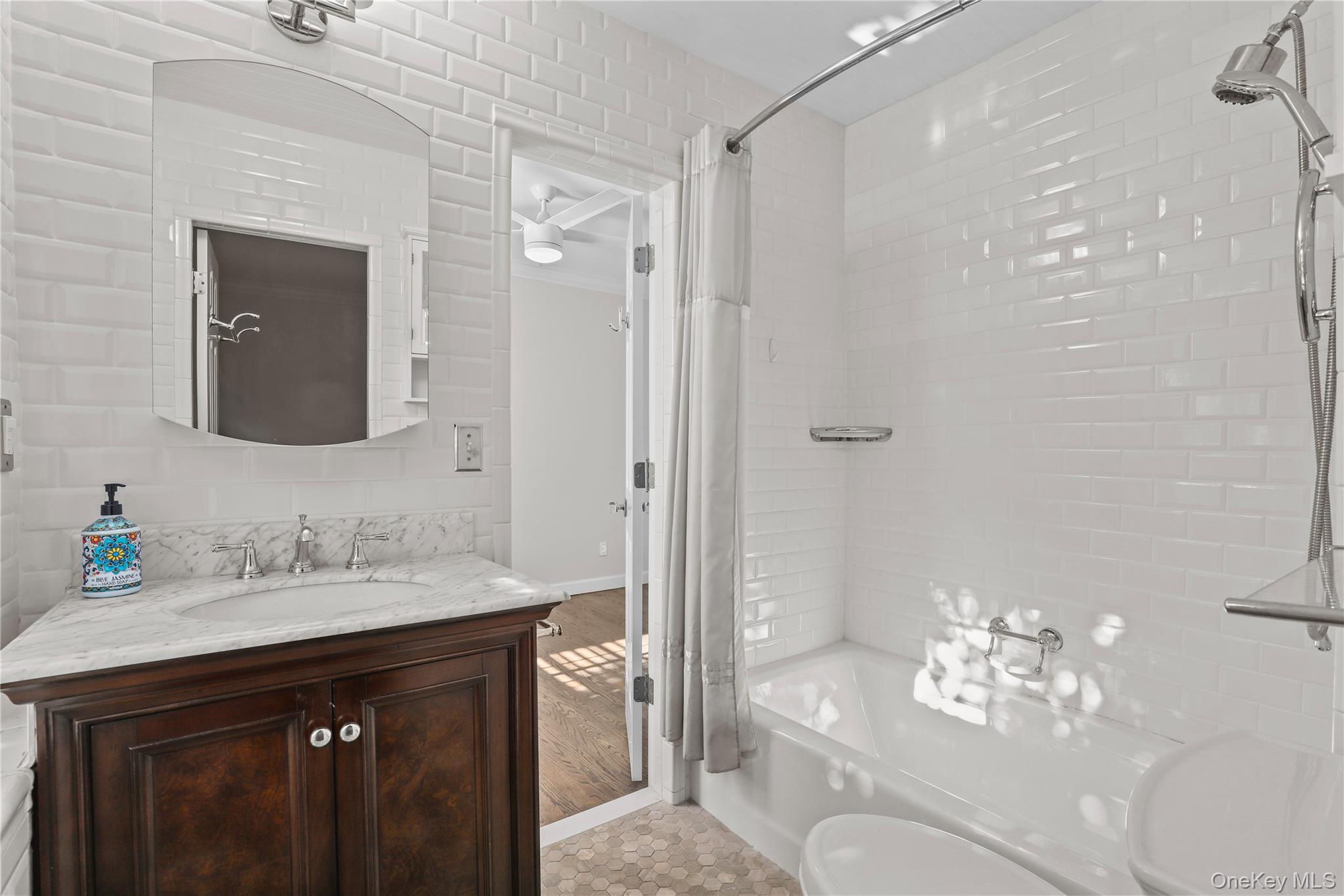 6 Brooklands, Unit GC Bronxville, NY 10708 - Photo 12 of 17 a bathroom with a double vanity sink mirror and shower