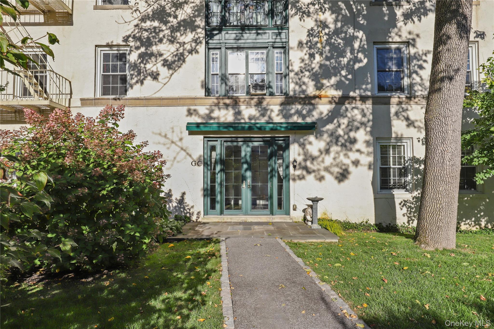 6 Brooklands, Unit GC Bronxville, NY 10708 - Photo 15 of 17 front view of a house with a yard