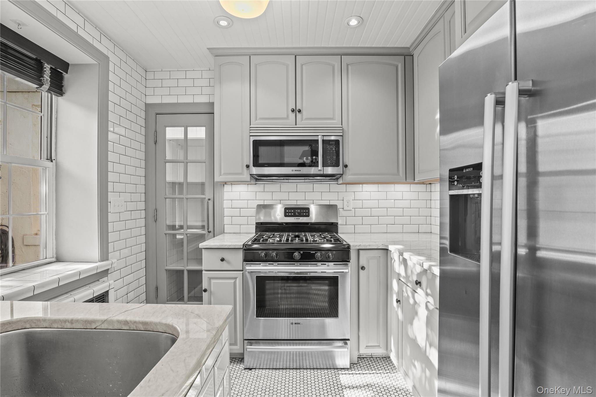 6 Brooklands, Unit GC Bronxville, NY 10708 - Photo 7 of 17 a kitchen with a stove and a refrigerator