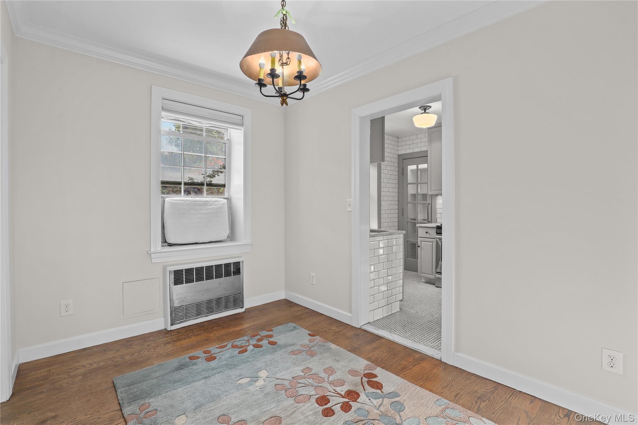 6 Brooklands, Unit GC Bronxville, NY 10708 - Photo 9 of 17 wooden floor with chandelier and window