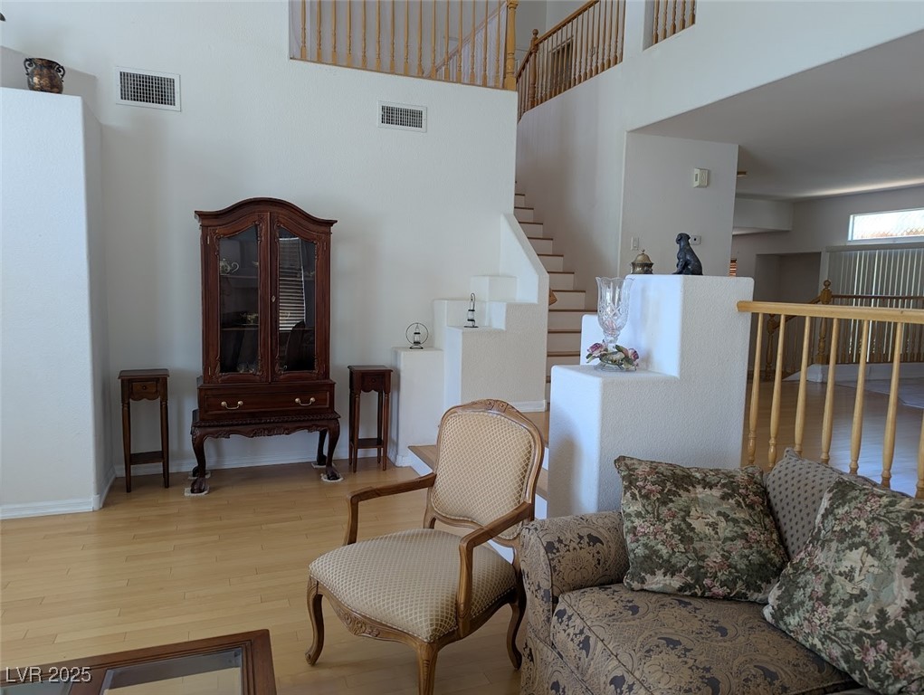 4777 Crakow Court Las Vegas, NV 89147 - Photo 11 of 49 Living area featuring wood finished floors and a towering ceiling